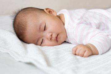 Baby girl asleep on her tummy