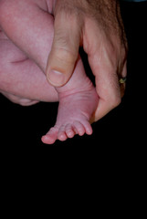Father Holding Baby Foot