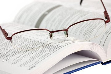 Dictionary with glasses on the white