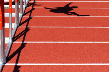 Shadow of a person jumping over the hurdles