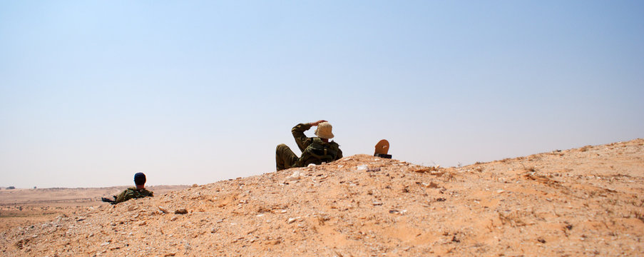 Men sitting on desert landscape