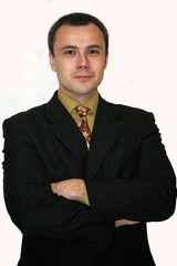 Portrait of successful businessman folding his arms