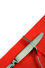 fork and knife on a red napkin