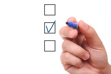 List of checkboxes and hand with pen on white background