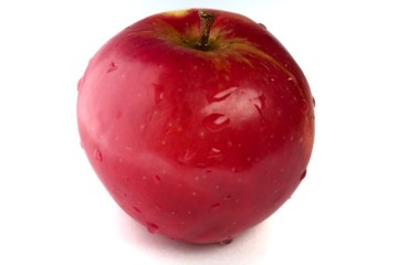 Delightful red apple, with water droplets, on a white background
