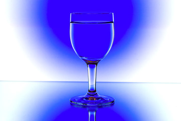 domino wine glasses in backlight on the blue and white contrast