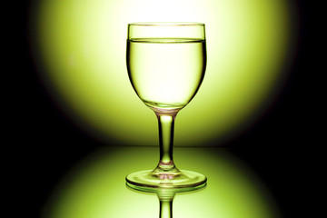 wine glasses in backlight on the black and yellow contrast backg
