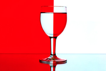 domino wine glasses in backlight on the red and white contrast b