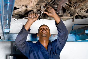 african mechanic working on a vehicle