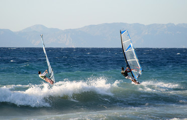 Two windsurfers starting the ride