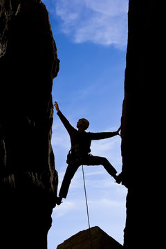 Rock climber reaching.