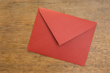 Closed Red Envelope on a Wooden Table