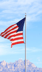 American flag waving over the organ mountains