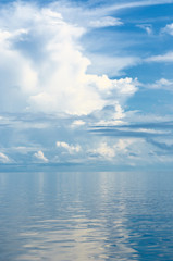 Naklejka na ściany i meble background of ocean and blue cloudy sky