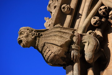 Close up shot of a church gargoyle against blue sky