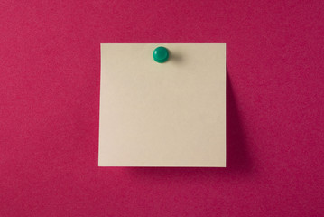 Blank yellow adhesive note on red