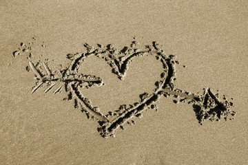 Heart and arrow - drawing in sand