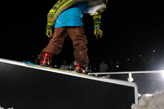 freestyle snowboarder jump in air at night