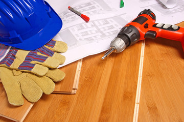 helmet and blueprint on wood floor