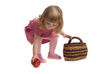 Little girl gather apples.