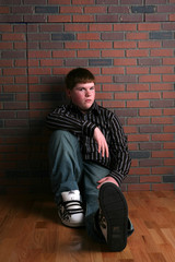 teenage boy sitting on floor