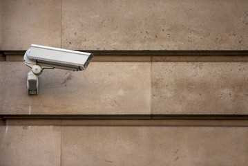 CCTV camera on stone-clad wall