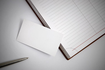 Empty business card with diary and pen