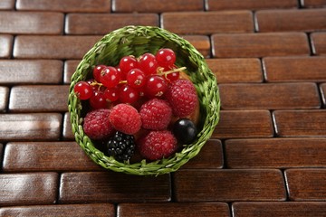 Mixed berries in a green little basket