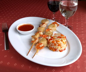Dish of Italian cuisine - seafood kebab (shashlik) with rice