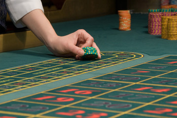 casino dealer handling gambling chips