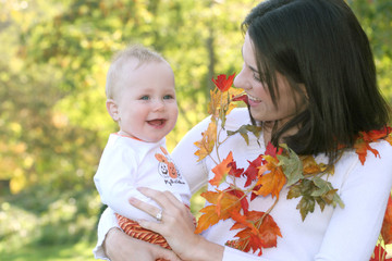 Obraz premium Mother and Baby Boy with Leaves - Fall Theme