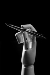 Mannequin wood hand with a pen to write