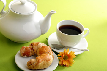 Breakfast concept with coffee and croissant
