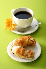 Breakfast concept with coffee and croissant