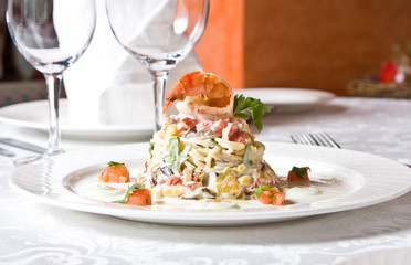 Dish from a baked eggplant, pepper, a spaghetti, shrimps,salad,
