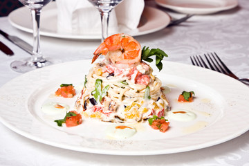 Dish from a baked eggplant, pepper, a spaghetti, shrimps,salad,