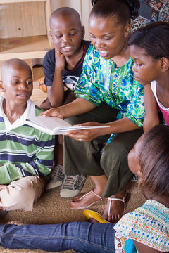 african mother reading to her 4 children