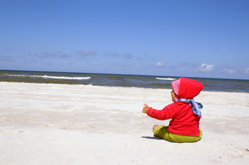 Girl sits on beach