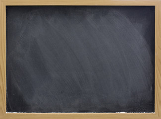 blank blackboard with white chalk dust and smudges
