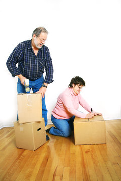 Senior Couple Packing Cardboard