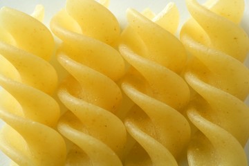 Spiral fusilli dired pasta macro over white