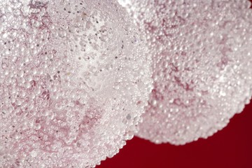 Balls over red background, transparent white spheres