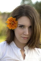 Naklejka premium Pretty Woman with Orange Flower