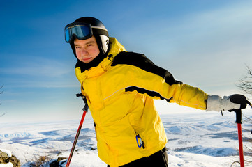Fototapeta na wymiar Young skier standing on mountains