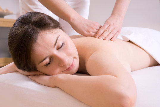 girl getting a back massage in the spa salon