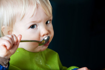 Child Eating with Spoon
