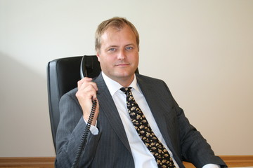 Swedish business man waiting for client by telephone