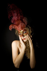 woman with Venetian mask and red feathers