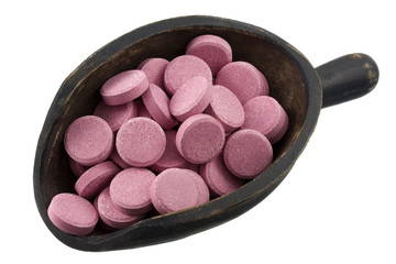 scoop of pink pills (tablets)
