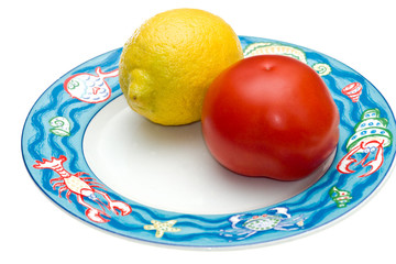 Tomato and Lemon on a elegant dish.
